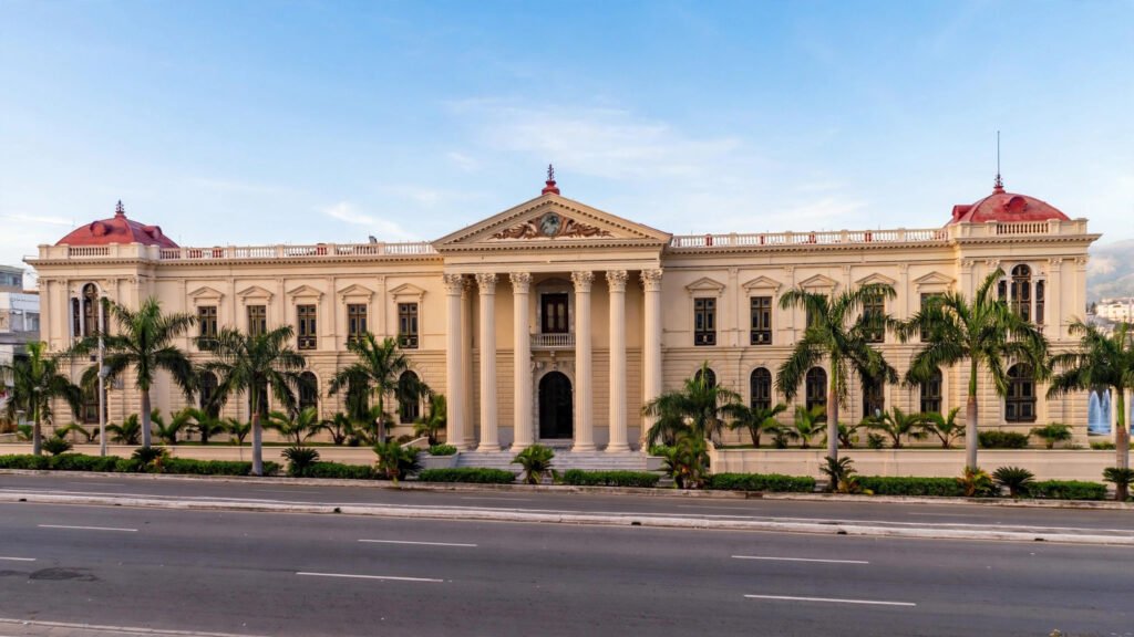 A neoclassical government building with palm trees in San Salvador, El Salvador.